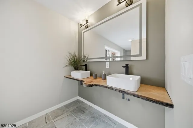 a bathroom with a sink a mirror and a toilet