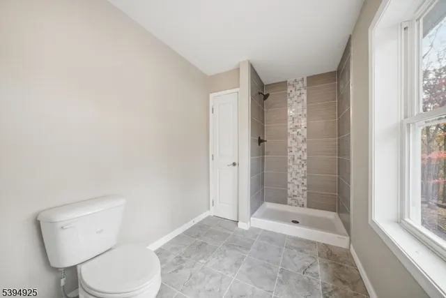 a bathroom with a toilet and shower