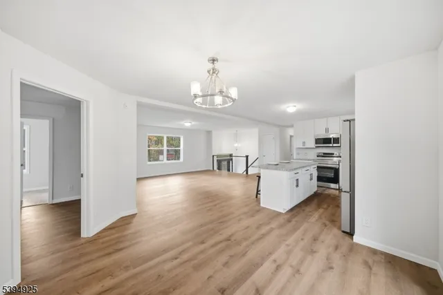 a view of kitchen with cabinets and wooden floor