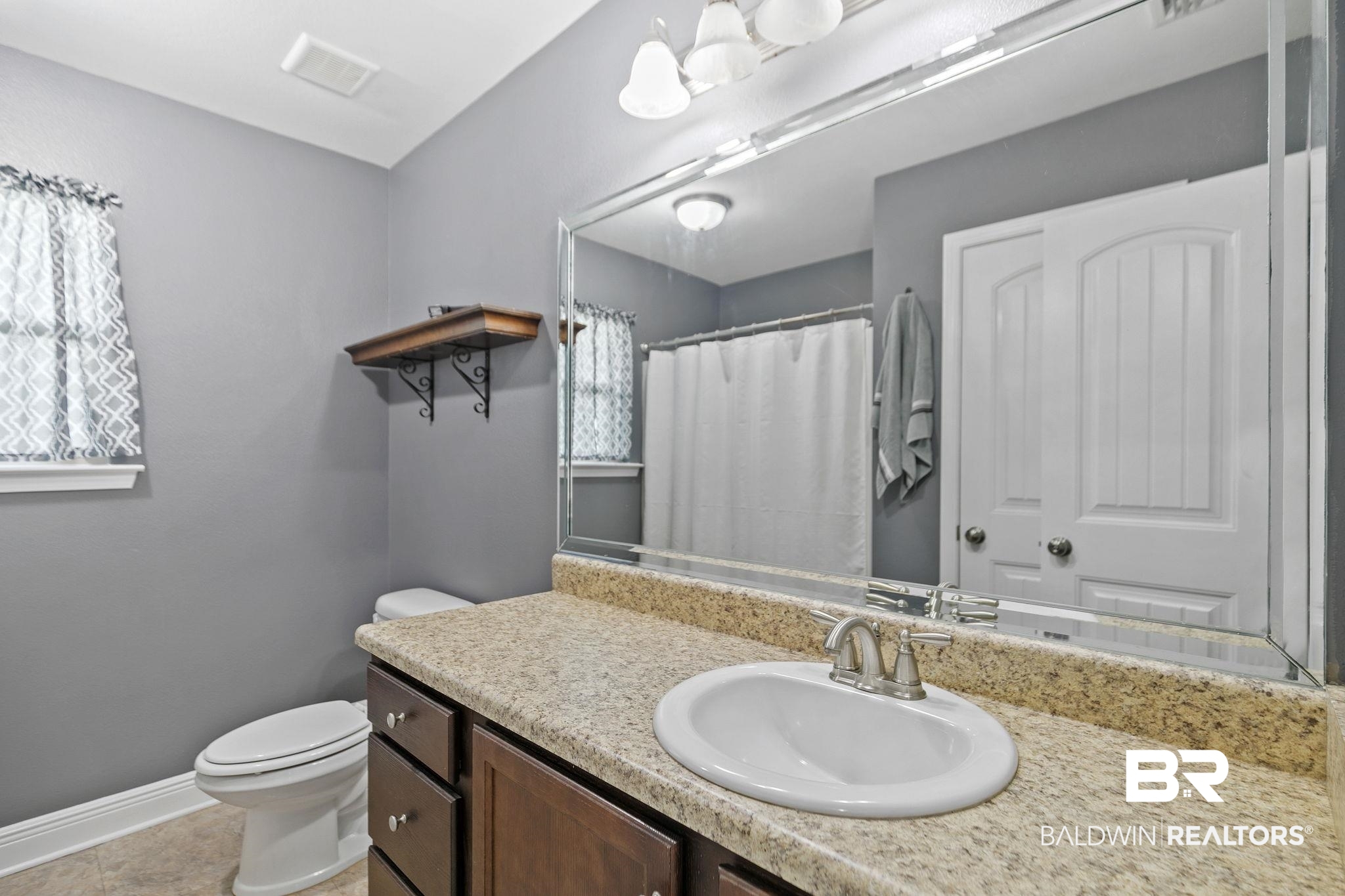 15573 Talus Court Foley, AL 36535 - Photo 30 of 50 Bathroom with tile patterned floors, vanity, and toilet