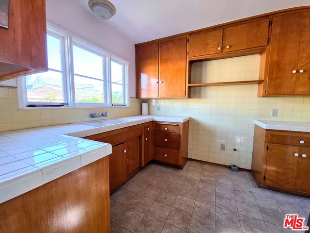 a kitchen with sink cabinets and window
