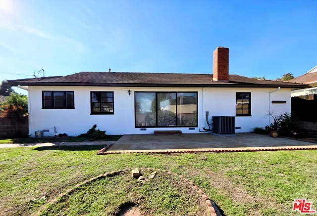 a front view of a house with a yard outdoor seating and garage