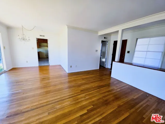 a view of a room with wooden floor and stairs