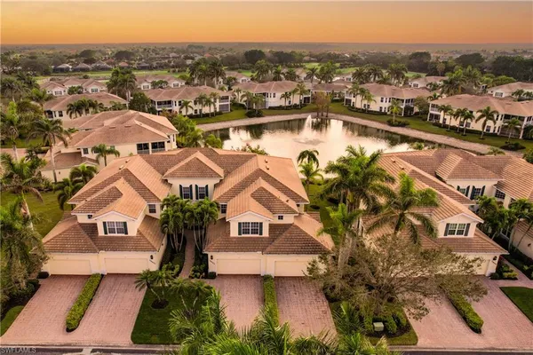 an aerial view of residential houses with outdoor space and river