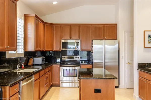 a dining room with furniture a window and a flat screen tv