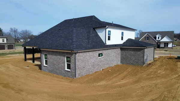 a front view of a house with yard and garage