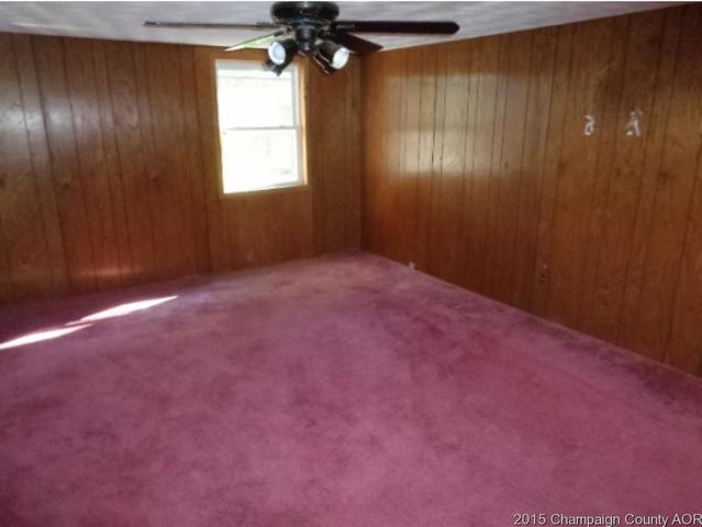 785 Iuka Road Iuka, IL 62849 - Photo 14 of 17 an empty room with windows and chandelier fan