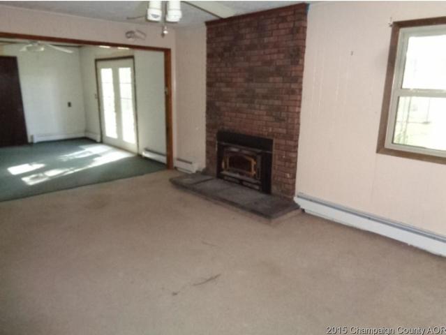 785 Iuka Road Iuka, IL 62849 - Photo 7 of 17 an empty room with windows and fireplace