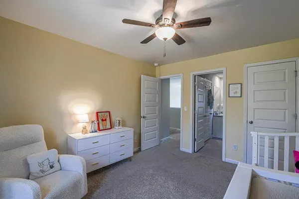 a living room with furniture and a baby crib