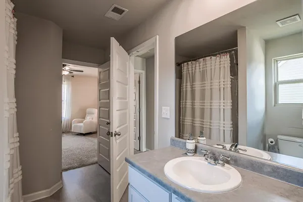 a en suite bathroom with a double vanity sink and a mirror
