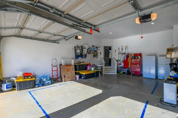 a view of an empty room with floor to ceiling window and stairs