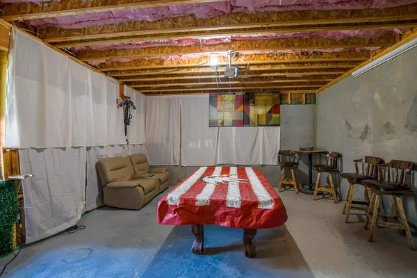 a bedroom with furniture and wooden floor