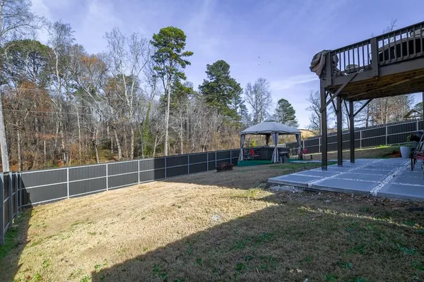 a view of a backyard with swimming pool and sitting area