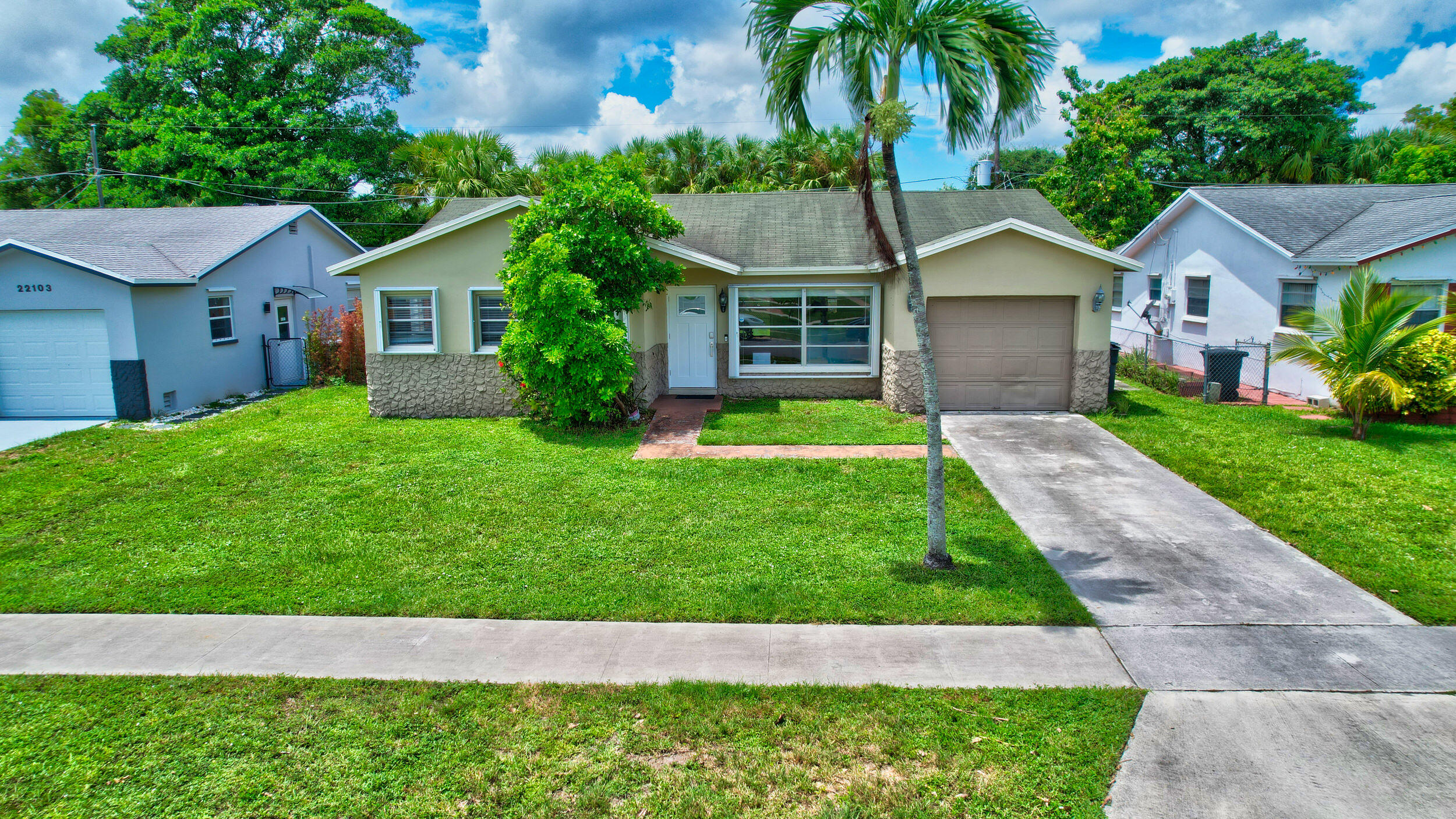 a aerial view of a house with a yard and potted plants