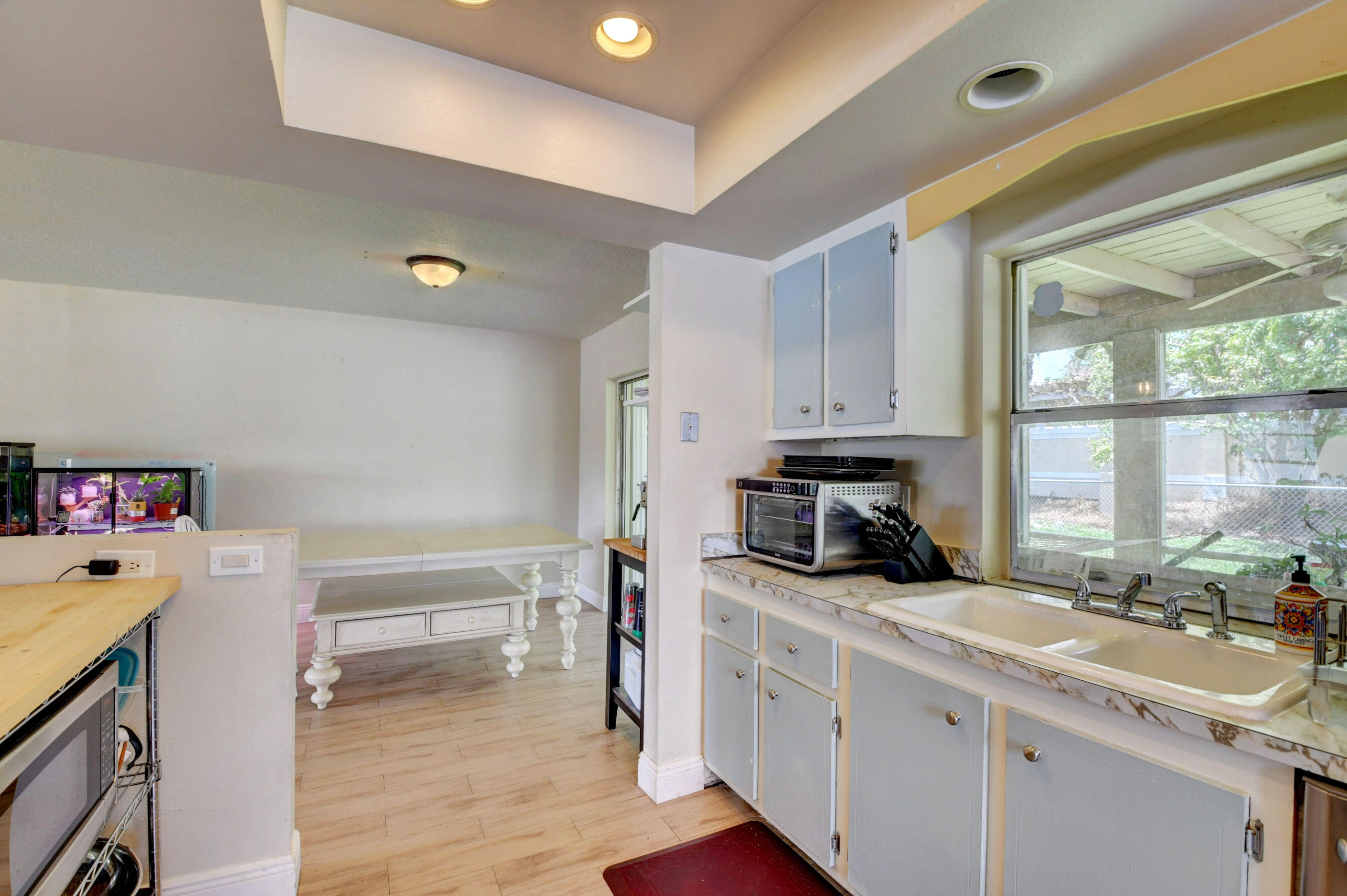 22093 Southwest 58th Avenue Boca Raton, FL 33428 - Photo 13 of 36 a kitchen with a sink cabinets and a window
