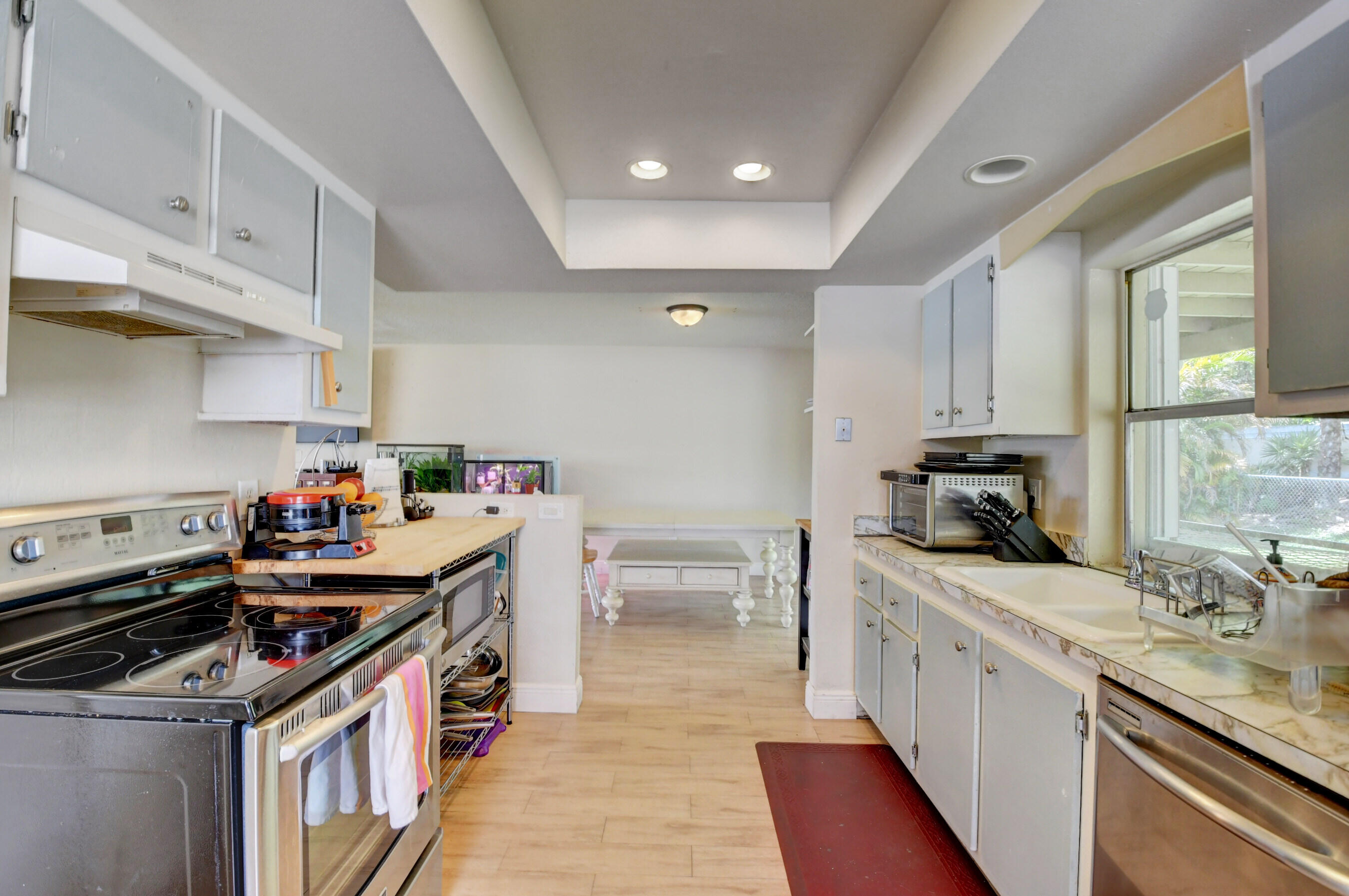 22093 Southwest 58th Avenue Boca Raton, FL 33428 - Photo 14 of 36 a kitchen with stove cabinets and a sink