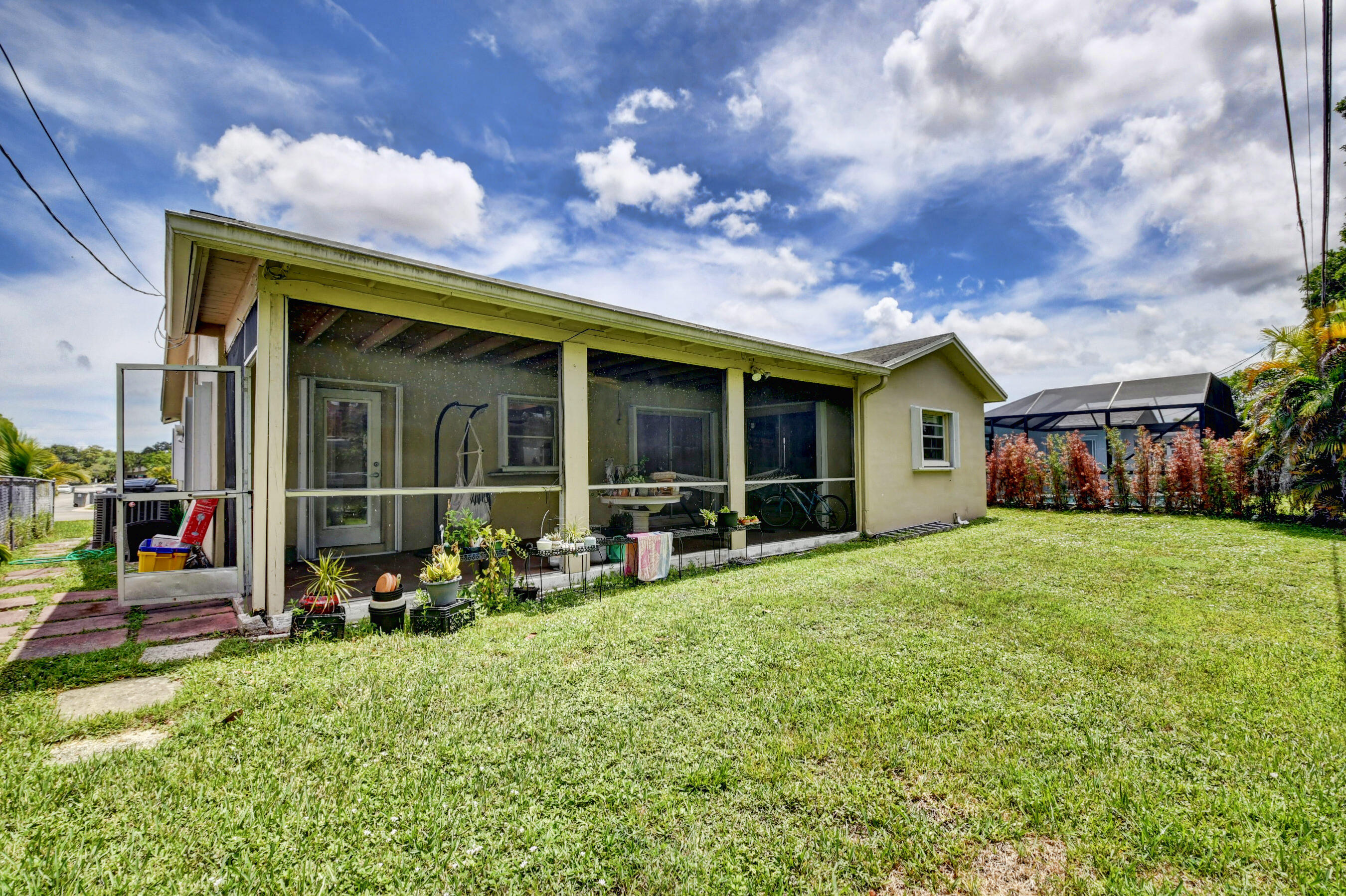 22093 Southwest 58th Avenue Boca Raton, FL 33428 - Photo 26 of 36 a front view of a house with a yard