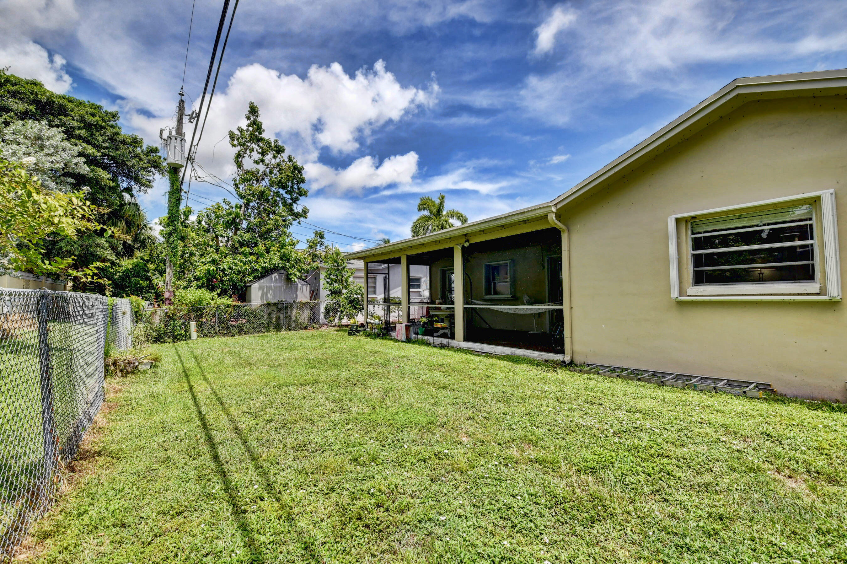 22093 Southwest 58th Avenue Boca Raton, FL 33428 - Photo 29 of 36 a view of a backyard with plants and large tree