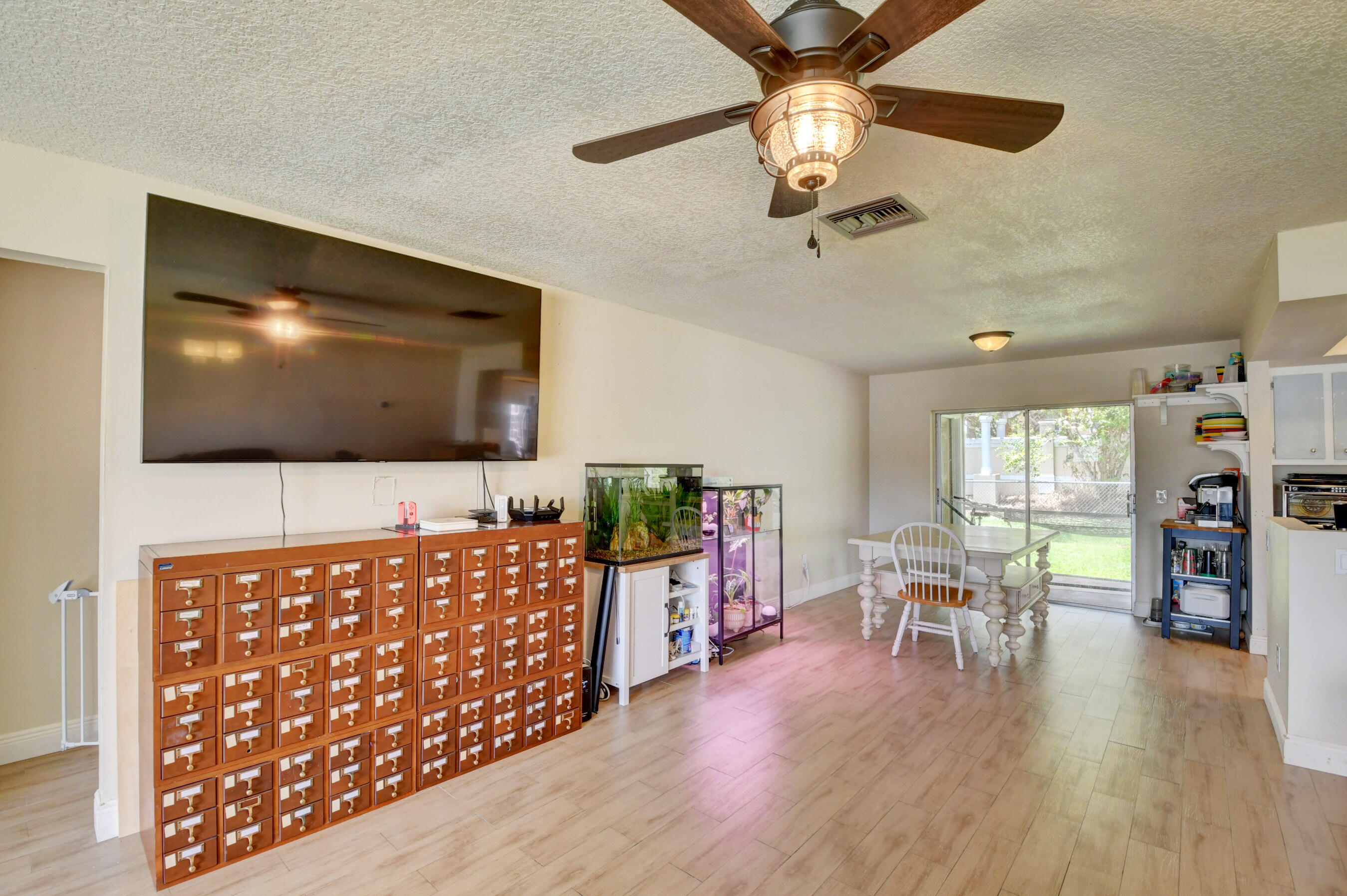 22093 Southwest 58th Avenue Boca Raton, FL 33428 - Photo 3 of 36 a living room with furniture and a flat screen tv