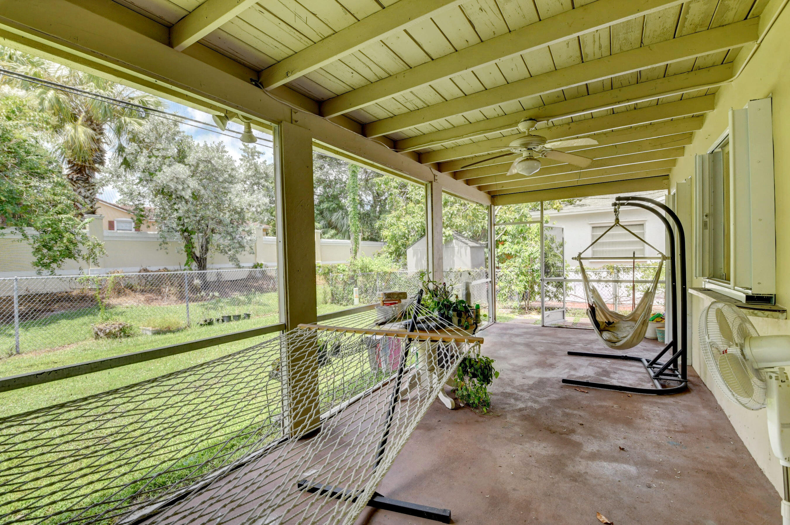 22093 Southwest 58th Avenue Boca Raton, FL 33428 - Photo 5 of 36 a view of a porch with furniture and garden