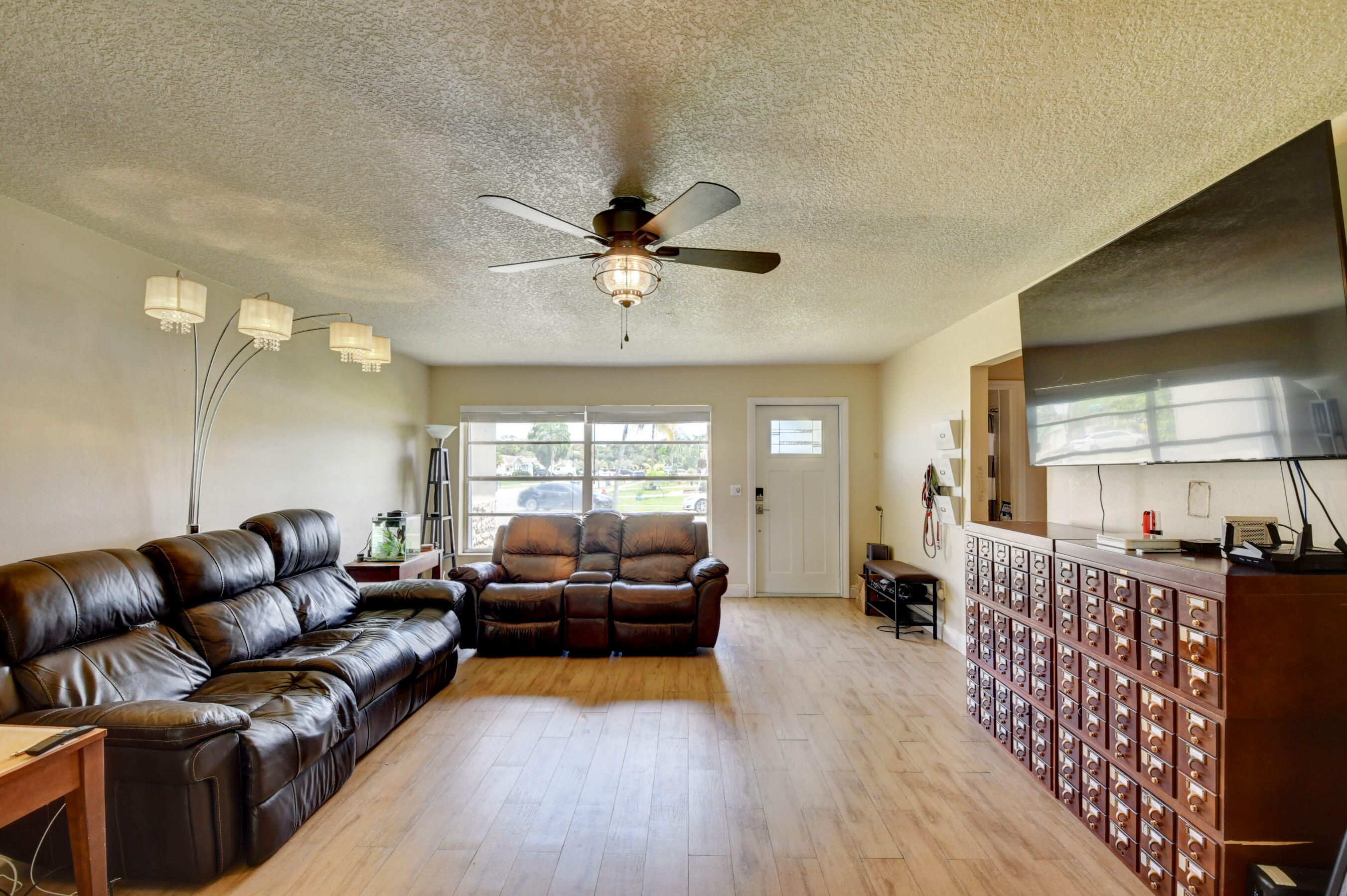 22093 Southwest 58th Avenue Boca Raton, FL 33428 - Photo 7 of 36 a living room with furniture and a large window
