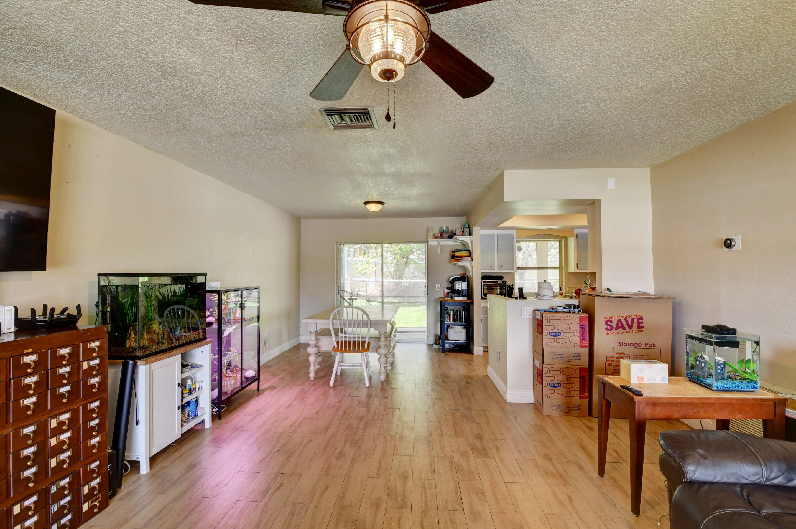 22093 Southwest 58th Avenue Boca Raton, FL 33428 - Photo 9 of 36 a living room with furniture flat screen tv and wooden floor