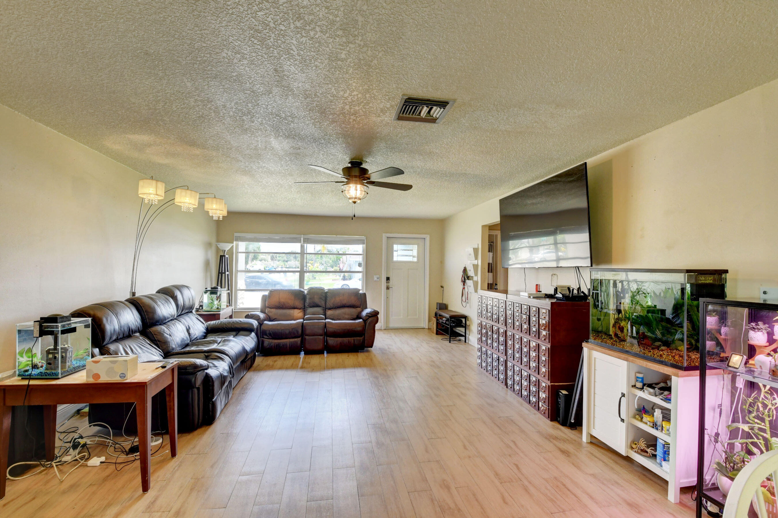 22093 Southwest 58th Avenue Boca Raton, FL 33428 - Photo 10 of 36 a living room with furniture and a flat screen tv