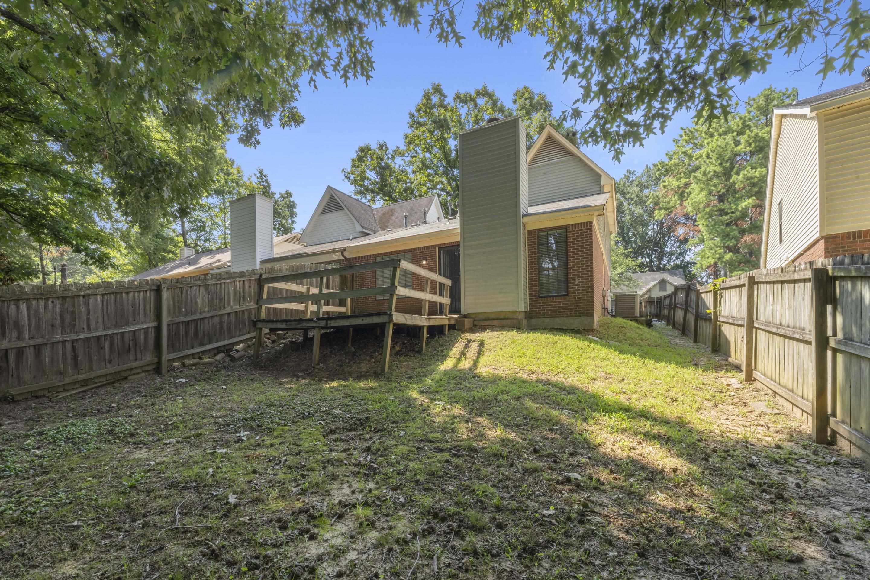2252 Mangum Road Memphis, TN 38134 - Photo 23 of 23 Expansive backyard featuring a wood deck, mature trees, and a full privacy fence
