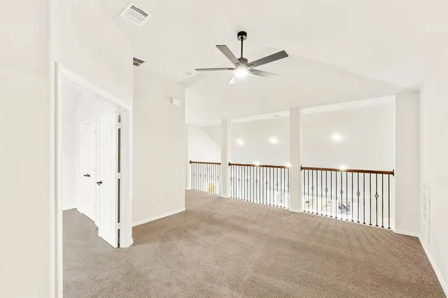 a view of a hallway with a ceiling fan