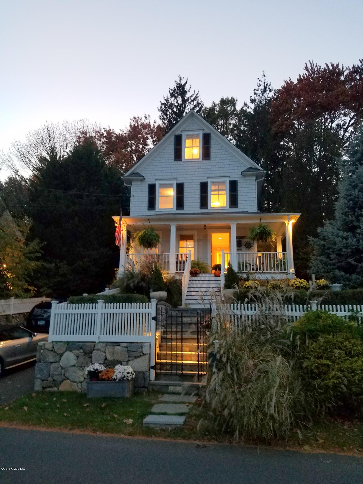 36 Arch Street Riverside, CT 06878 - Photo 37 of 37 a front view of a house with garage and plants