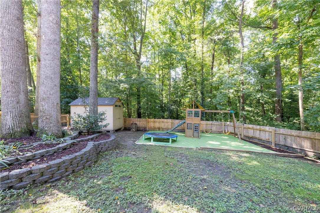 13907 Barnes Spring Road Midlothian, VA 23112 - Photo 41 of 43 a view of a backyard with a small cabin