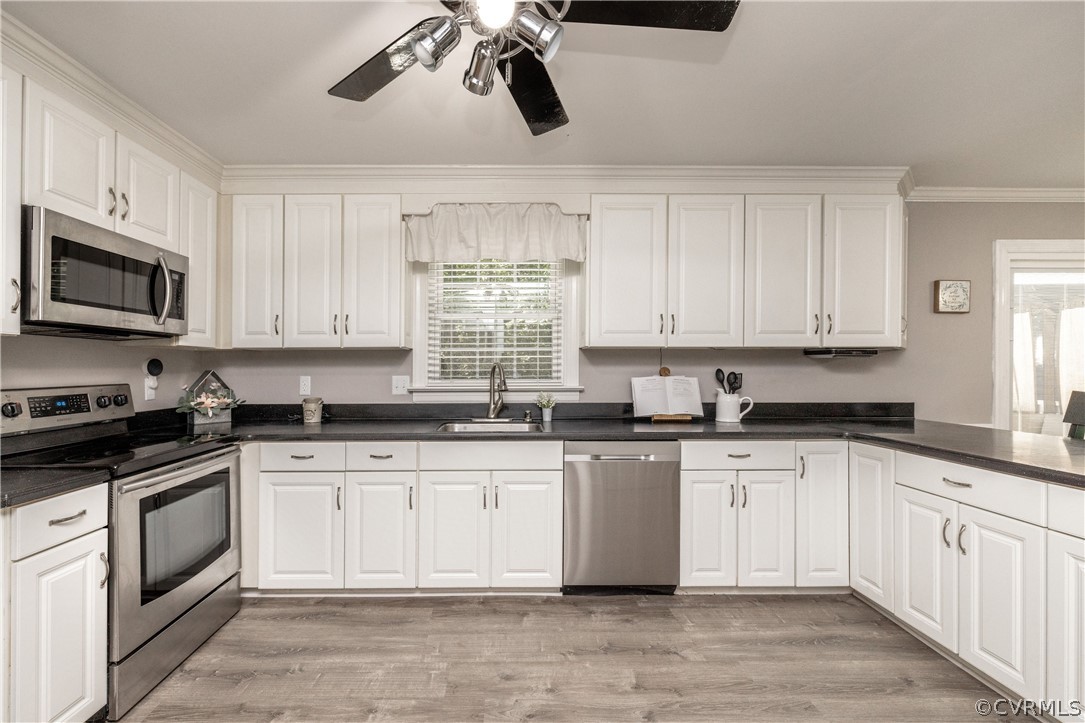 13907 Barnes Spring Road Midlothian, VA 23112 - Photo 9 of 43 a kitchen with stainless steel appliances granite countertop a sink a stove top oven and white cabinets