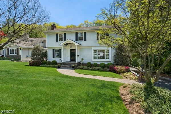 a front view of a house with a yard and porch