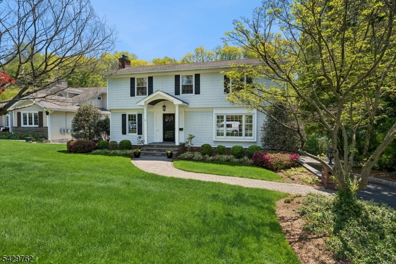 a front view of a house with a yard and porch