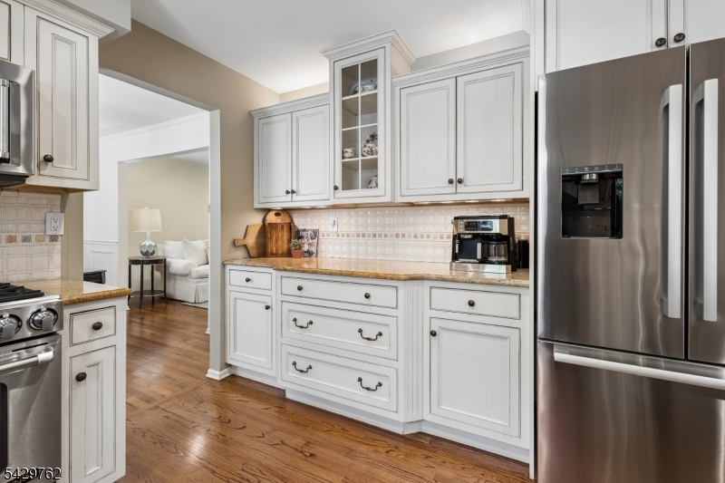 738 Springfield Avenue Summit, NJ 07901 - Photo 14 of 29 a kitchen with stainless steel appliances white cabinets and wooden floors