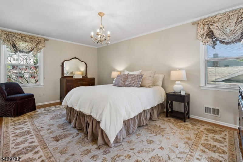 738 Springfield Avenue Summit, NJ 07901 - Photo 15 of 29 a bedroom with a bed mirror and furniture