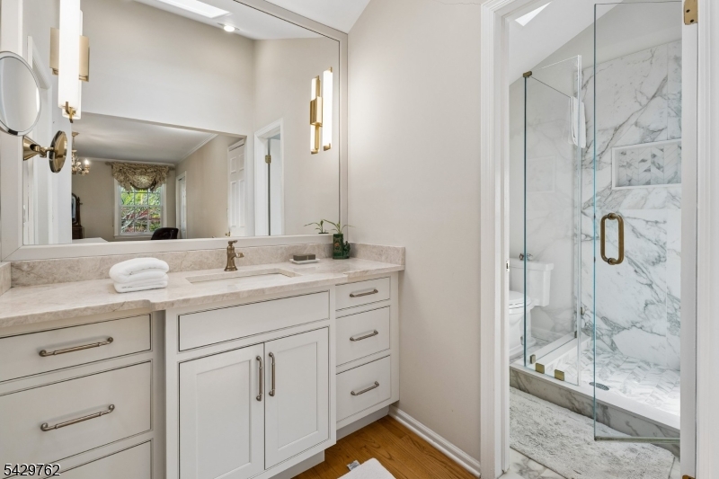 738 Springfield Avenue Summit, NJ 07901 - Photo 17 of 29 a bathroom with a granite countertop sink mirror and shower