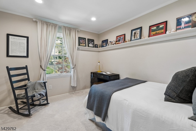 738 Springfield Avenue Summit, NJ 07901 - Photo 18 of 29 a bedroom with a bed and a window