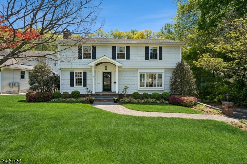 738 Springfield Avenue Summit, NJ 07901 - Photo 2 of 29 a front view of a house with a yard and porch