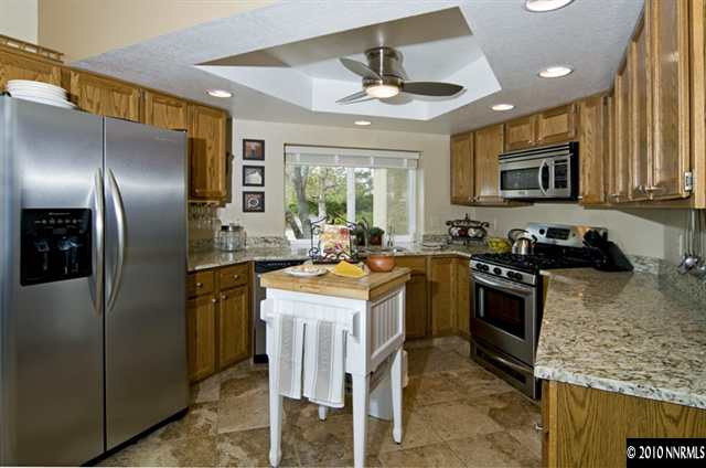 2205 Snowmass Drive Reno, NV 89511 - Photo 4 of 9 a kitchen with stainless steel appliances granite countertop a sink stove and refrigerator
