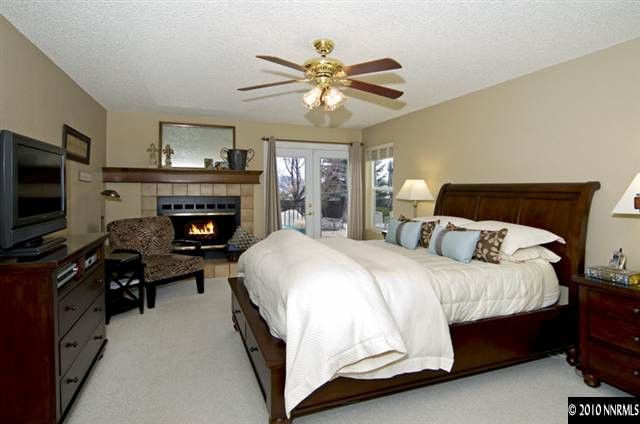 2205 Snowmass Drive Reno, NV 89511 - Photo 6 of 9 a spacious bedroom with a bed and a flat screen tv