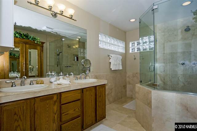 2205 Snowmass Drive Reno, NV 89511 - Photo 7 of 9 a bathroom with a double vanity sink mirror and shower