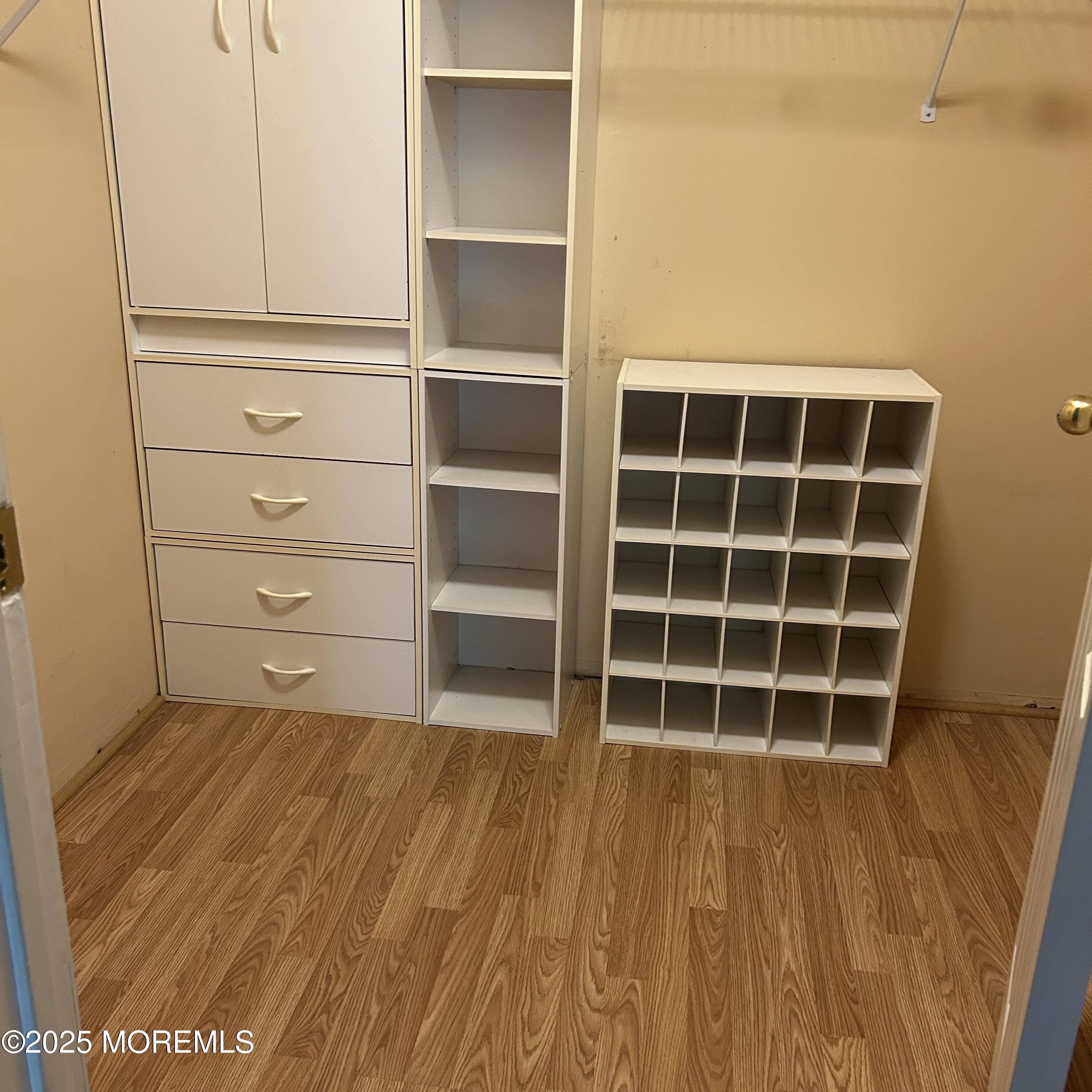 71 Overlook Way, Unit H Manalapan, NJ 07726 - Photo 5 of 5 a view of an empty room with wooden floor and a window