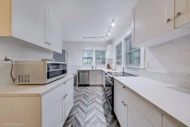 a kitchen with a sink stove and microwave