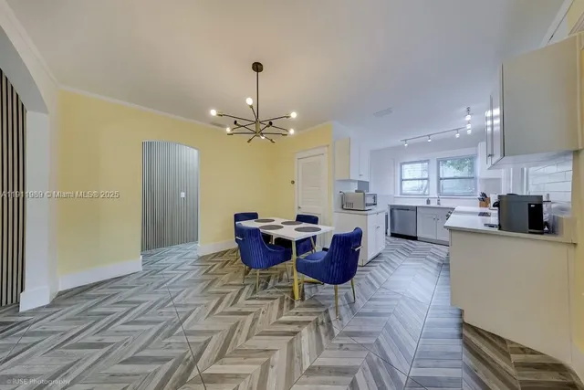 a view of a dining room with furniture and chandelier