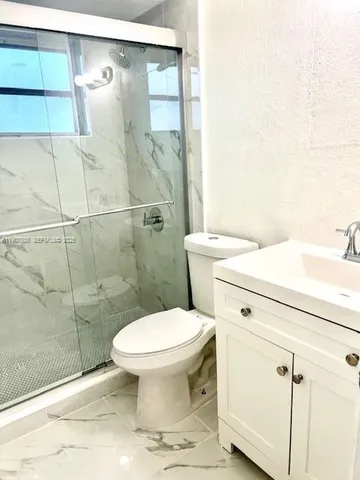 a bathroom with a toilet sink and shower
