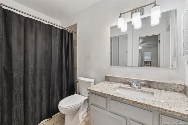 a bedroom with a bed and a flat tv screen on the dresser