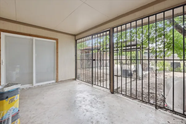 a view of a patio with table and chairs and potted plants