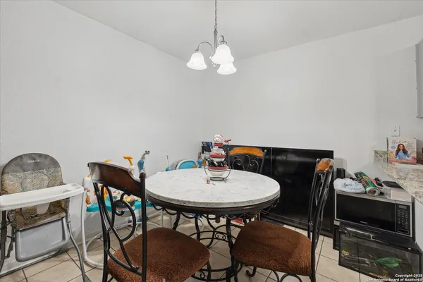 a kitchen with stainless steel appliances granite countertop a sink stove refrigerator and cabinets