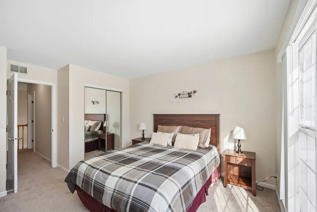 a bedroom with a bed and a lamp